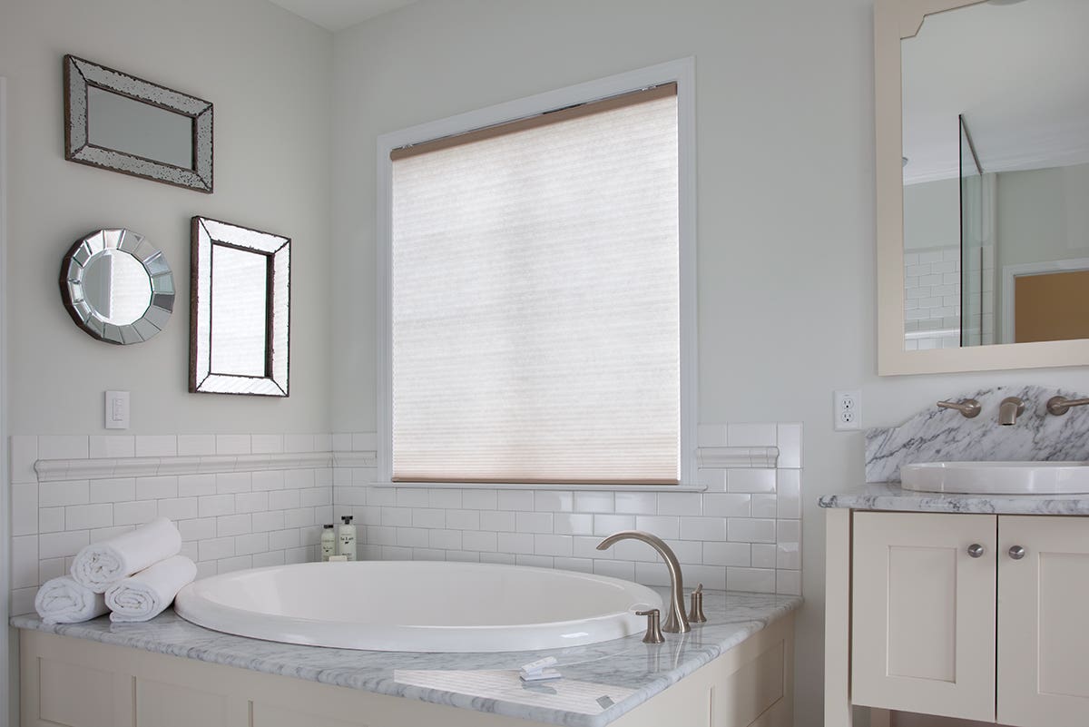Chic, bright bathroom with closed light filtering honeycomb shades