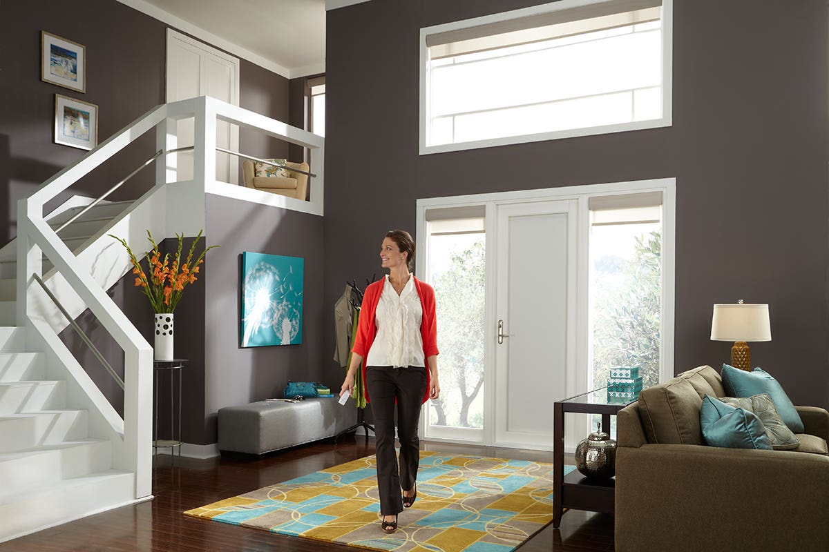 Woman in Foyer with Translucent Roller Shades on Windows