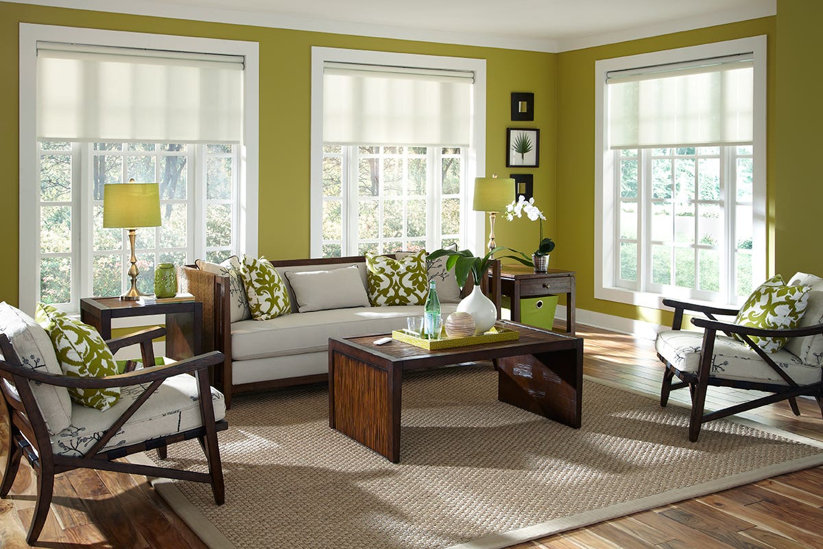 Bright Green Sunroom With White Roller Shades