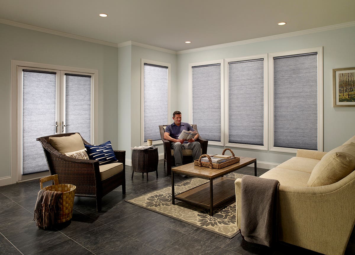 Man in Sunroom with Closed Honeycomb Shades in Color Storm