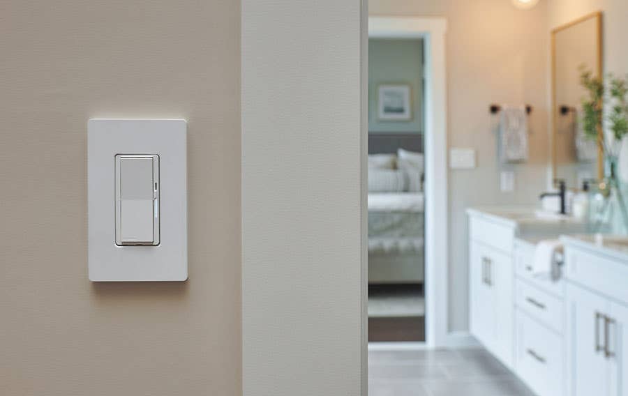 close-up of Lutron Diva Smart Dimmer on wall in front of bathroom