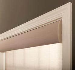 Motorized roller shades in window