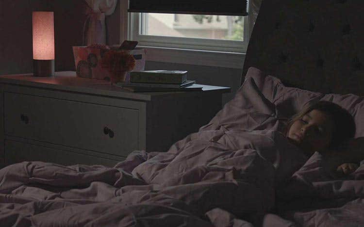 Young girl in bed sleeping, lights out with night light on