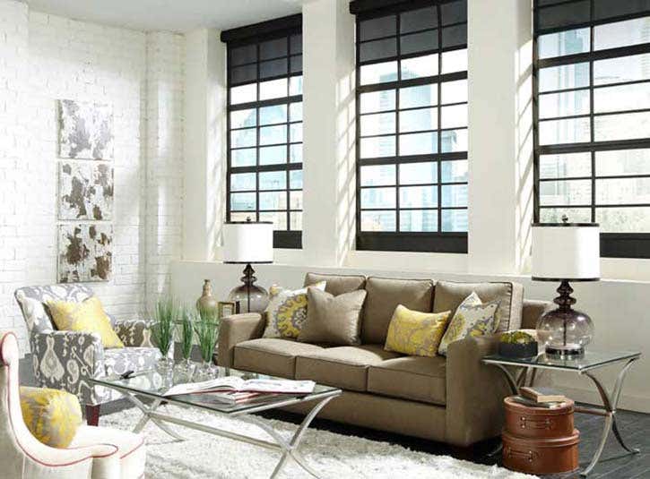 Smart blackout blinds in a room with couch that has accent pillows, coffee table, and side tables